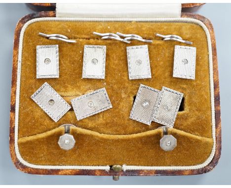 A cased 1930's engine turned silver eight piece dress stud set, by Henry Griffiths &amp; Sons Ltd.