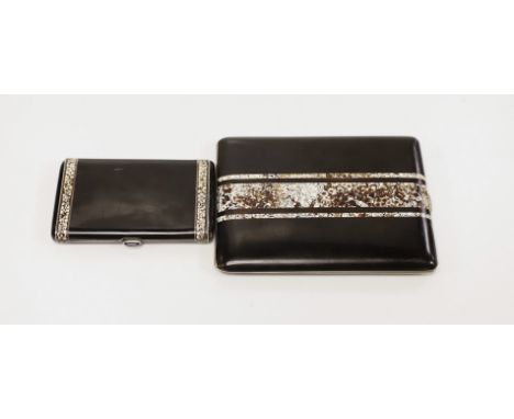 A French Art Deco white metal, black lacquer and eggshell banded cigarette case, with cabochon button, 8cm and one other simi