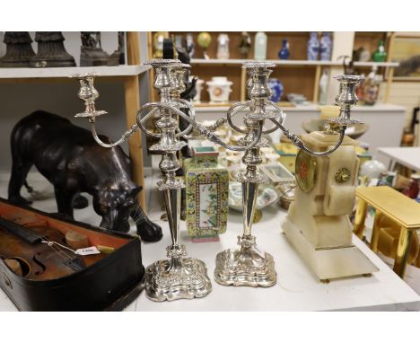 A pair of plated three light, two branch candelabra, 49cm tall