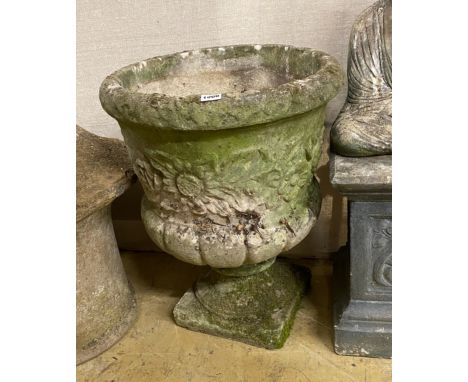 A circular reconstituted stone garden planter, diameter 47cm, height 60cm