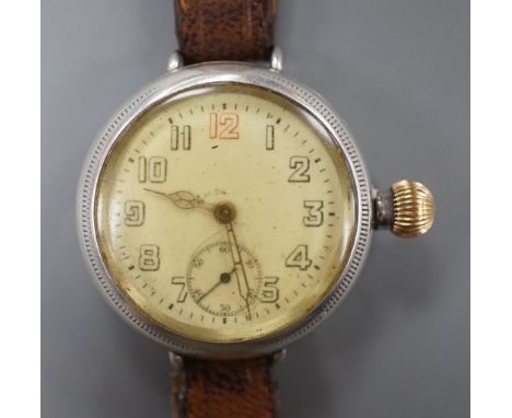 A gentleman's early 20th century silver manual wind wrist watch with Zenith movement, on associated leather strap.