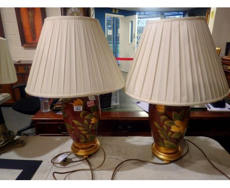 Pair of ceramic table lamps with shades, decorated with flowers, H: 70 cm. All electrical items in this lot have been PAT tes