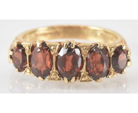 A 9ct gold ring set with five graduated garnets, size O, approx 5.3g.