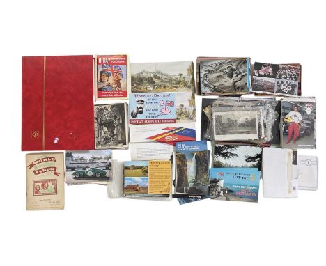 A collection of assorted all world postcards and first day covers, and an empty stamp album.