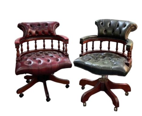 A reproduction green leather button upholstered revolving desk chair and a matching red leather button upholstered revolving 
