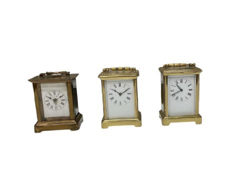Three brass cased carriage clocks, all with white enamel dials set with Roman numerals, height of tallest 11cm (3). 