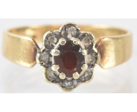 A 9ct yellow gold red and white stone set flower head ring, size M, approx 2.6g.