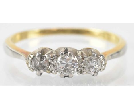 An 18ct yellow gold three stone diamond ring, the central stone approx 1ct, flanked by two smaller stones, each approx 0.05ct