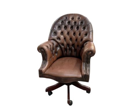 A reproduction brown leather button upholstered revolving desk chair (af).