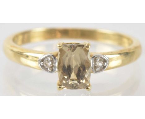 A 9ct yellow gold csarite and Ratanakiri zircon set ring, the central csarite approx 1.1ct, flanked by two small zircons, siz