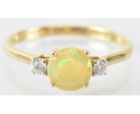 A 9ct yellow gold white zircon and opal set ring, the central opal approx 0.7ct, flanked by two white zircons, combined appro