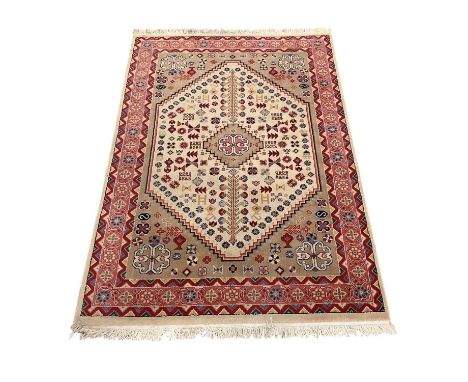A modern red and cream ground Iranian carpet with geometric designs, 230 x 150cm.