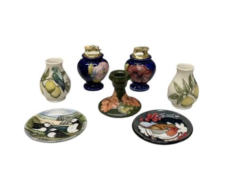 MOORCROFT; a 'Hibiscus' pattern green ground squat candlestick, height 8.5cm, puffin dish, diameter 11.5cm, robbin dish, diam