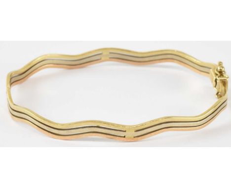 A 9ct yellow gold three strand bangle, diameter 5cm, approx 7g.