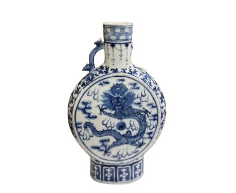A late 19th century Chinese blue and white porcelain moon flask, decorated with a dragon, height 25cm (af).Condition Report: 