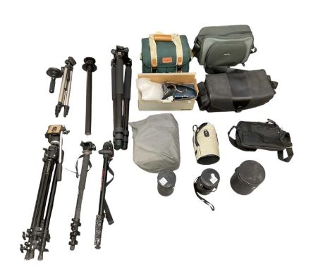A large quantity of camera equipment and accessories including bags, empty lens cases, straps, tripods, lens covers, etc (qty