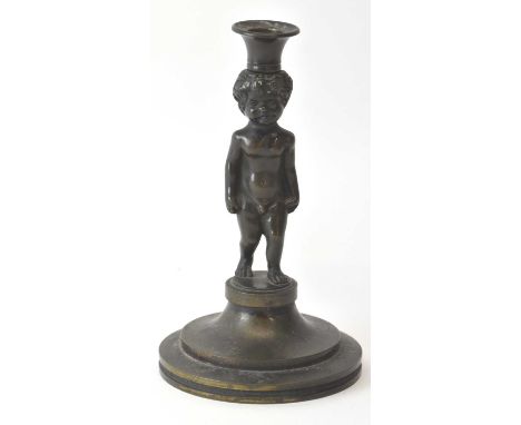 A small late 19th century bronze figural candlestick modelled as a cherub, height 14.5cm.