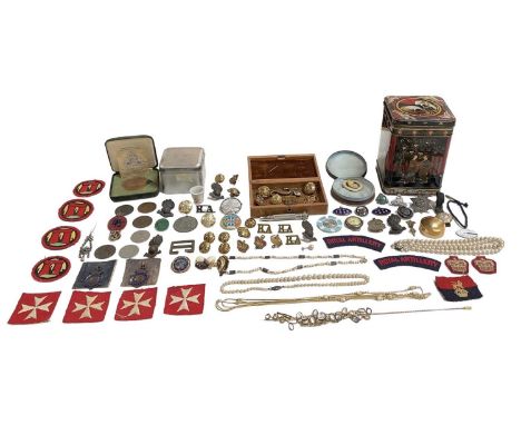 A collection of military badges, buttons, cup badges, uniform badges, a seal, a Royal Mint Palace of Westminster bronze medal