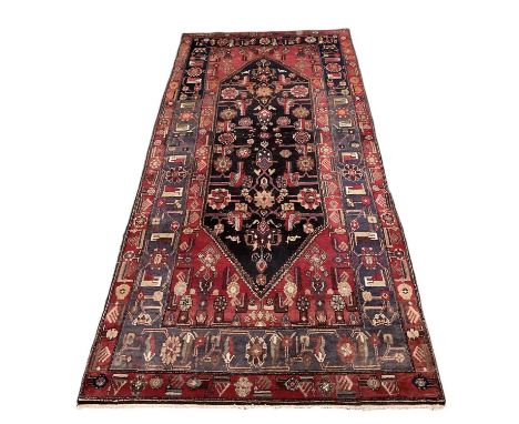 A Persian type red ground carpet with geometric designs, 320 x 156cm.