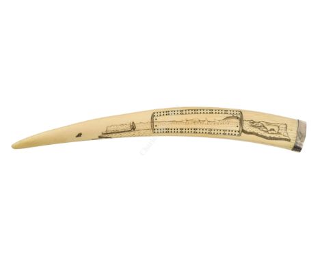 Ø A LARGE INUIT SCRIMSHAW DECORATED CRIBBAGE BOARD WALRUS TUSK, CIRCA 1910 the top depicting an Inuit with his canoe, and pol