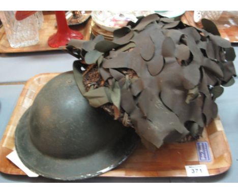 British post war helmet with camouflage, together with a British World War Two helmet. (2)(B.P. 24% incl. VAT)