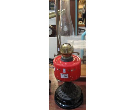 Early 20th Century brass double burner oil lamp with ceramic reservoir, metal pedestal and black ceramic base with clear chim