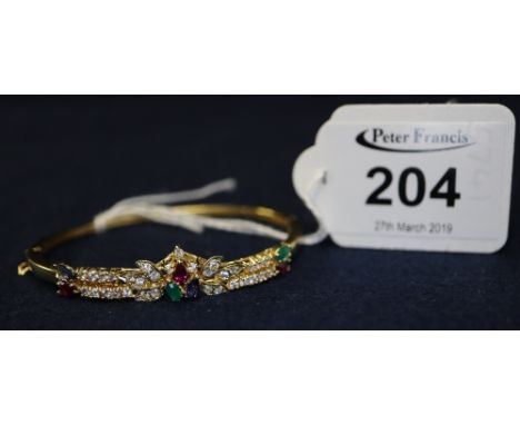 18ct gold gem set bangle. (B.P. 24% incl. VAT)
