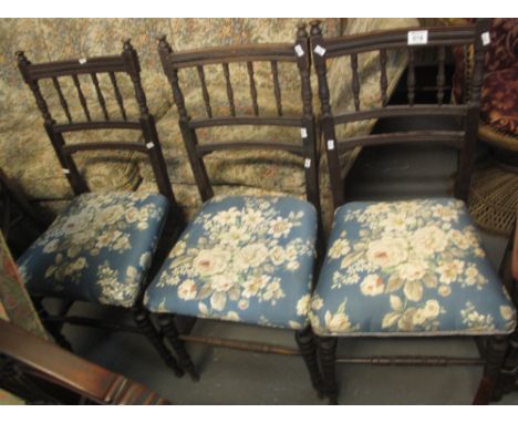 Set of three stained spindle back upholstered chairs on ring turned legs, together with an Edwardian slat back inlaid bedroom