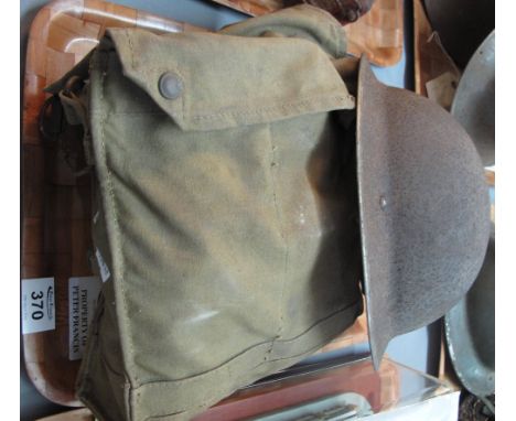 World War Two tommy helmet, together with gas mask in canvas bag. (B.P. 24% incl. VAT)