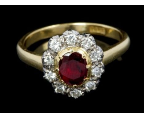 Gold (18ct) ruby and diamond cluster ring with an oval mixed cut ruby surrounded by ten brilliant cut diamonds, in collet set