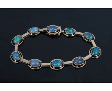 Opal triplet bracelet with ten oval black opal triplets in yellow metal setting, stamped '9ct', 18cm length CONDITION REPORT 