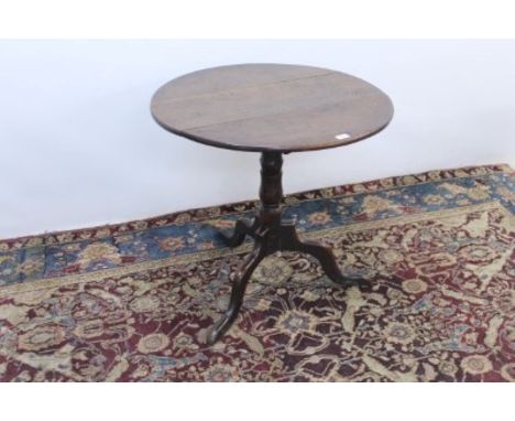 George III oak circular tilt top table on turned column and tripod base, 74cm diameter 						
