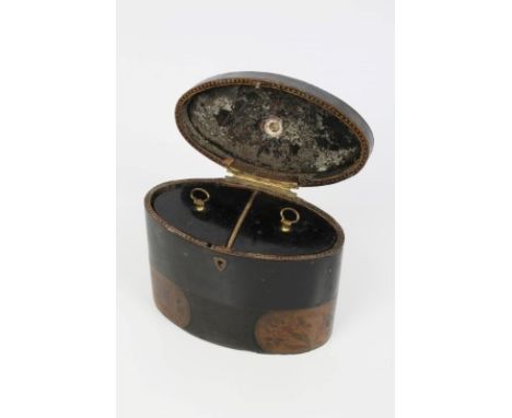 George III oval papier mâché tea caddy, ebonised with penwork panels of flowers, loop handle to top, interior fitted with two
