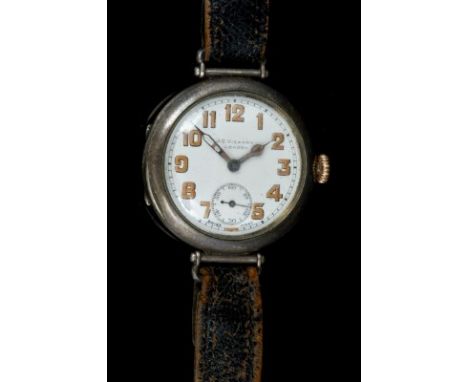 First World War officers' watch in silver circular case with swivel lugs, white enamel dial retailed by J C Vickery, London w