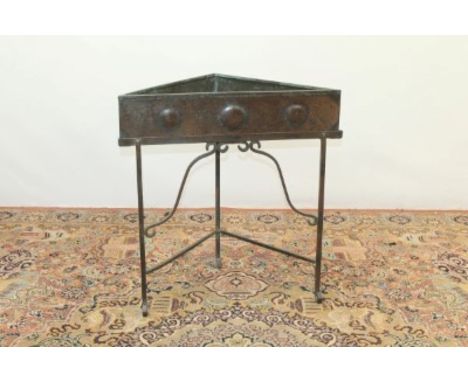 Arts & Crafts copper triangular planter on stand with scroll feet, 73cm wide