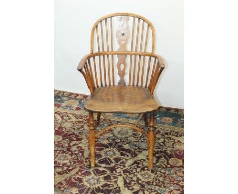 Antique yew wood and elm stick back Windsor elbow chair with central splat back, on turned legs joined by shaped stretcher