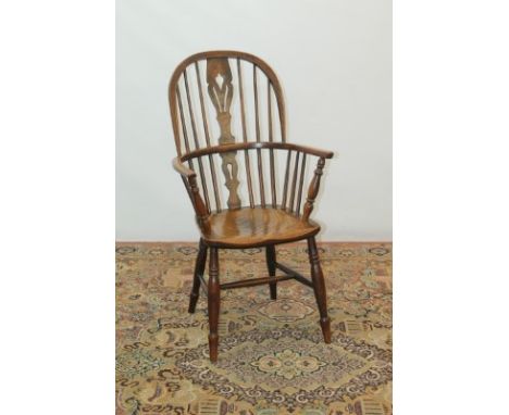 19th century elm Windsor elbow chair with pierced splat back, on turned legs joined by stretchers and a similar stick back ki