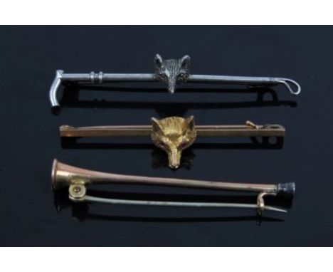 Edwardian cast yellow metal fox head bar brooch, similar white metal brooch and a yellow metal brooch in the form of a huntin