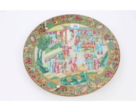 Late 19th century Cantonese porcelain charger with painted court scene within bird, insect and floral painted border, on gilt