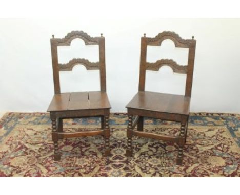 Pair of 17th century-style oak side chairs with shaped carved rail backs, o bobbin-turned and block legs joined by stretchers