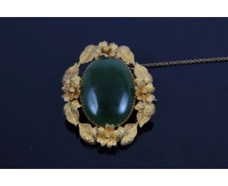 Antique Nephrite jade and yellow metal brooch with oval cabochon Nephrite panel, in cast yellow metal mount with textured flo