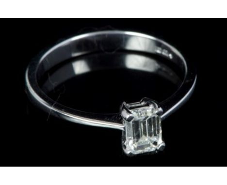 Diamond single stone ring with a rectangular emerald cut diamond estimated to weigh approximately 0.50 carats, in four claw s