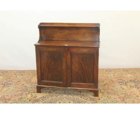 19th century mahogany chiffonier of small proportions, with raised ledge / shelf back, two panelled doors below, on bracket f