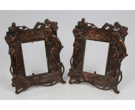 Pair of Art Nouveau coppered cast photograph frames, each with maidens wearing diaphanous gowns, with sinuous branches, easel
