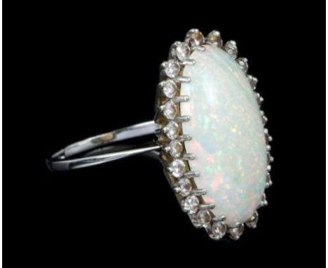 Opal and diamond cocktail ring with a large oval cabochon opal measuring approximately 22.3mm x 12.6mm x 4.4mm, surrounded by