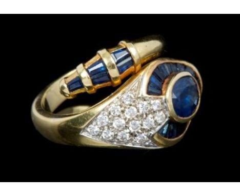 Gold (18ct) sapphire and diamond snake ring, the head with oval mixed cut blue sapphire surrounded by a border of baguette cu