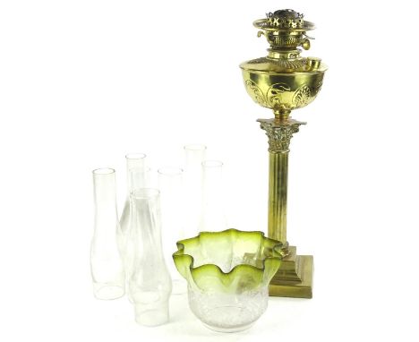 A Victorian Art Nouveau brass oil lamp, with a vaseline and floral etched shade, on a Corinthian column and stepped base, the