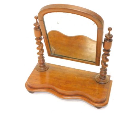 A late Victorian mahogany dressing table mirror, the arched plate on spirally turned supports with serpentine fronted base wi