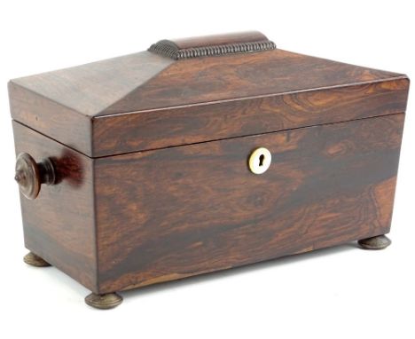 An early 19thC rosewood tea caddy, of sarcophagus form with turned handles on compressed feet, with part fitted interior, 22c