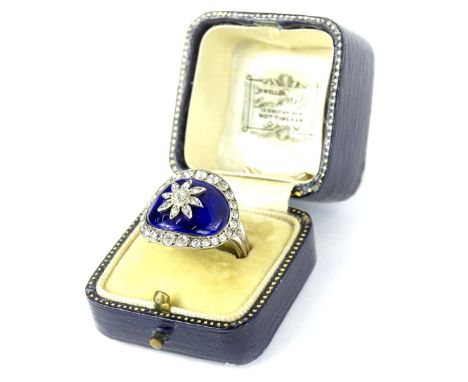 A late 19thC/early 20thC dress ring in George III style, with central oval blue enamel panel set with central floral design a